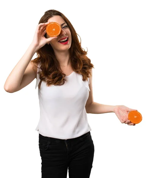 Beautiful young girl wearing orange slices as glasses — Stock Photo, Image