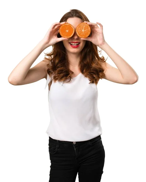 Beautiful young girl wearing orange slices as glasses — Stock Photo, Image