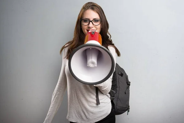 Φοιτητής γυναίκα φωνάζει από το megaphone σε φόντο με υφή — Φωτογραφία Αρχείου