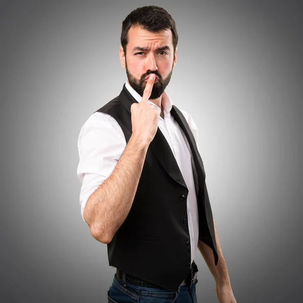 Cool man making horn gesture on grey background — Stock Photo, Image