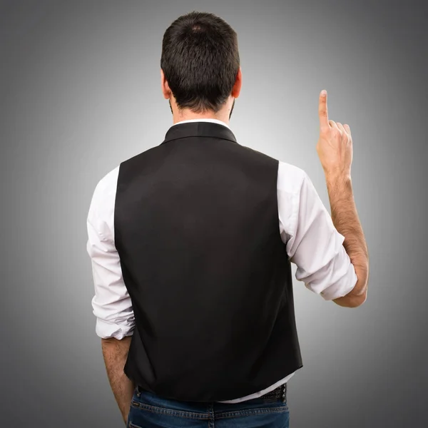 Cool man counting one on grey background