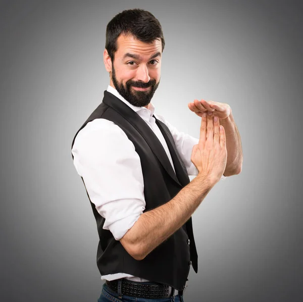 Cool man making time out gesture on grey background