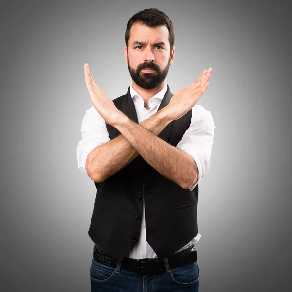 Cool man making NO gesture on grey background
