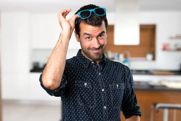 Happy Brunette man with sunglasses inside house — Stock Photo, Image