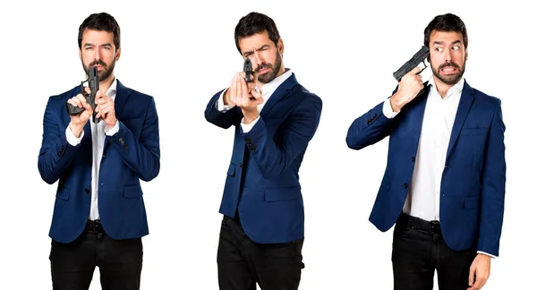 Handsome man holding a pistol — Stock Photo, Image