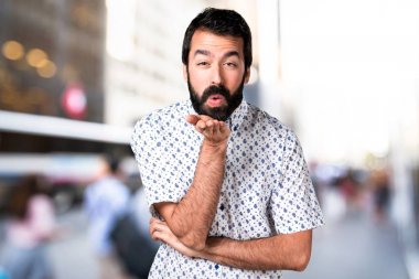 Bir öpücük gönderme sakallı yakışıklı esmer adam