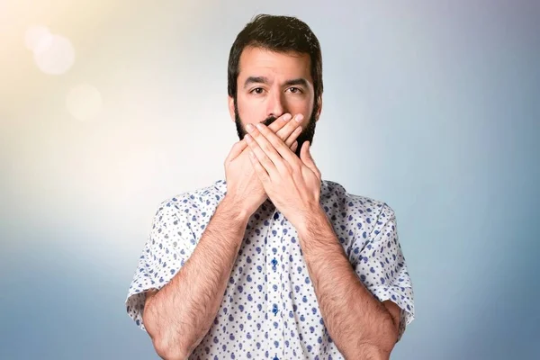 Handsome brunette man with beard covering his mouth — Stock Photo, Image