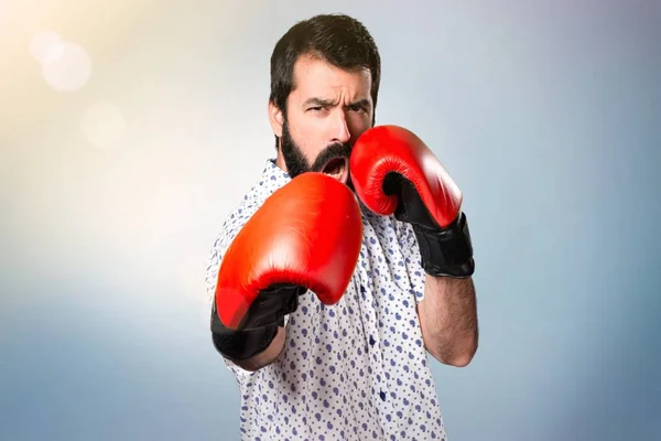 Handsome brunette man with beard with boxing gloves — Stock Photo, Image