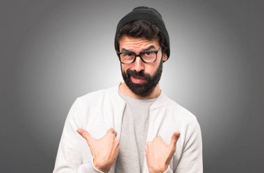 Hipster adam yapma sürpriz jest gri arka plan üzerinde