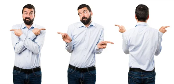 Set of Handsome man with beard pointing to the laterals having doubts — Stock Photo, Image