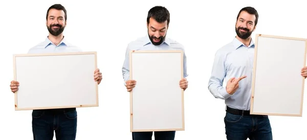 Conjunto de hombre guapo feliz con barba sosteniendo un cartel vacío —  Fotos de Stock