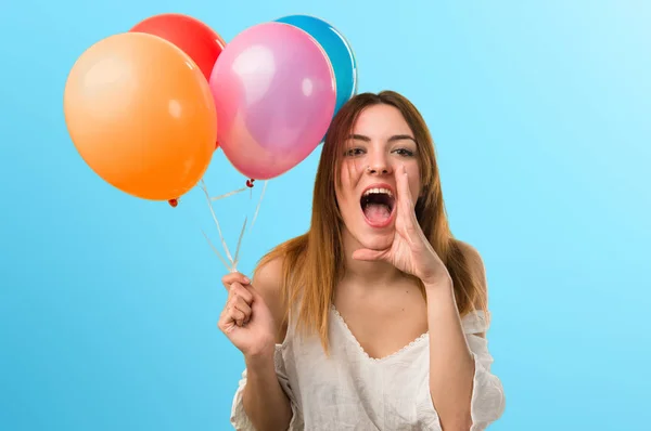 Hermosa joven sosteniendo un globo y gritando desenfocado — Foto de Stock