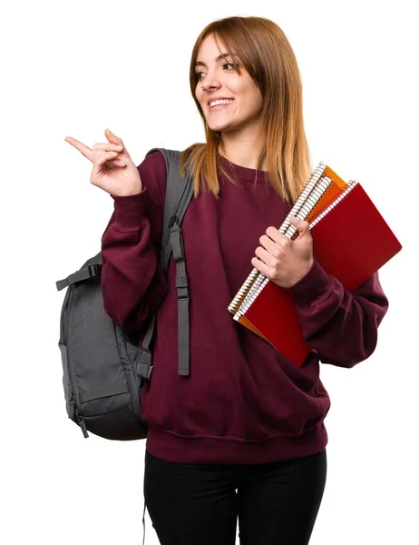 Mulher estudante apontando para a lateral — Fotografia de Stock