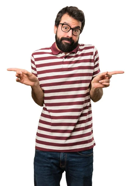 Man with glasses pointing to the laterals having doubts — Stock Photo, Image