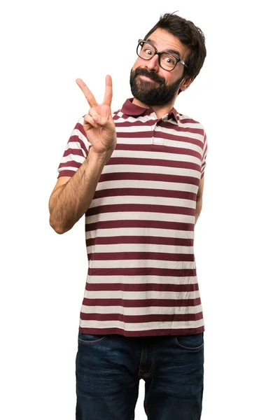 Man with glasses making victory gesture — Stock Photo, Image