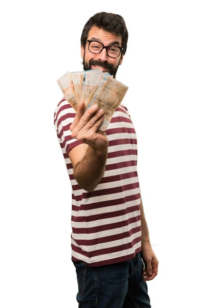 Hombre feliz con gafas cogiendo mucho dinero — Foto de Stock
