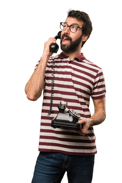 Man with glasses talking to vintage phone — Stock Photo, Image