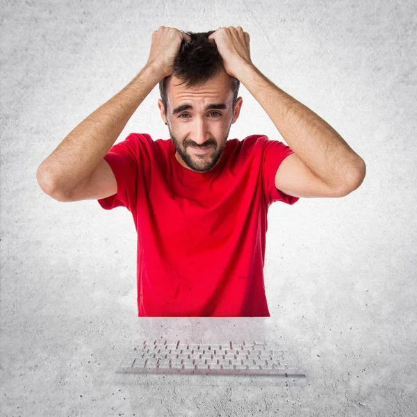 Frustrated computer technician working with his keyboard — Stock Photo, Image