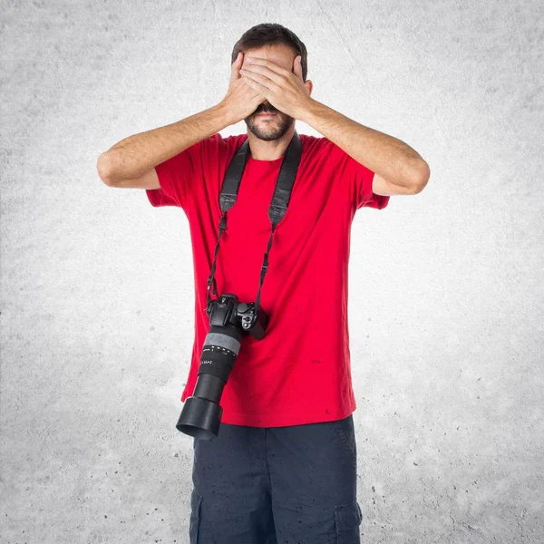 Photographer man covering his eyes — Stock Photo, Image