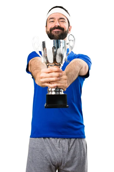 Funny sportsman holding a trophy on isolated white background — Stock Photo, Image