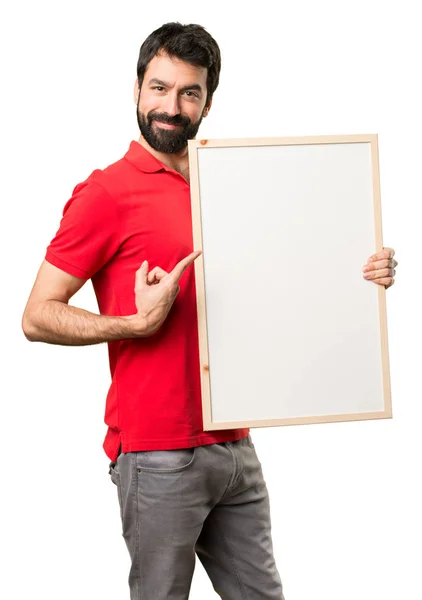 Homem bonito feliz segurando um cartaz vazio — Fotografia de Stock
