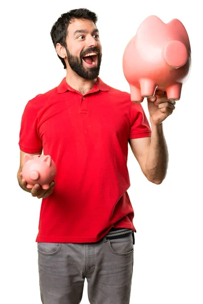 Hombre guapo sosteniendo una alcancía — Foto de Stock