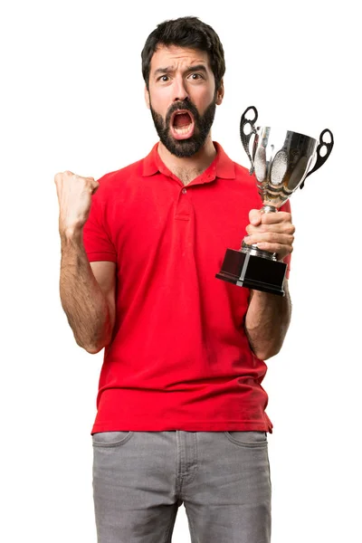 Handsome man holding a trophy Royalty Free Stock Images
