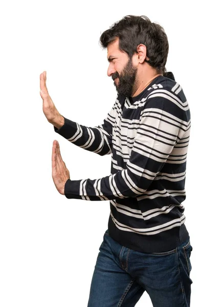 Man with beard pushing something — Stock Photo, Image