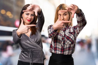 İki arkadaş odaklanmamış arka plan üzerinde duruluyor