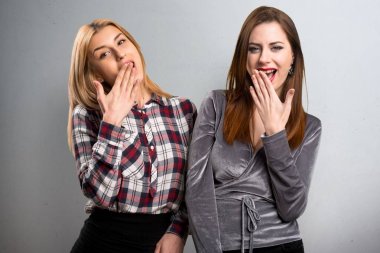 İki arkadaş sürpriz jest yapma dokulu arka plan