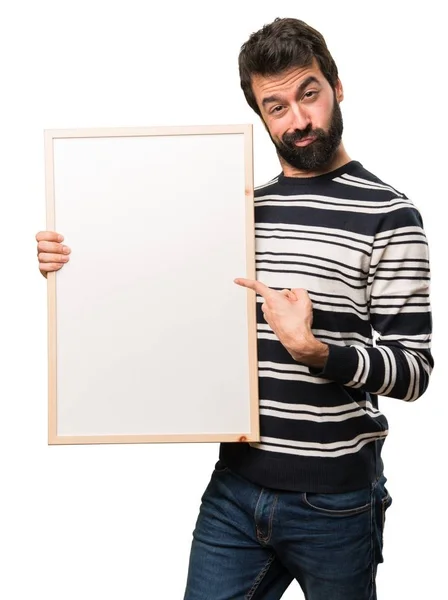 Человек с бородой держит пустой плакат — стоковое фото