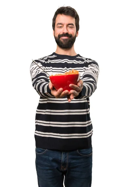 Happy Man with beard holding a bowl of cereals — Stock Photo, Image