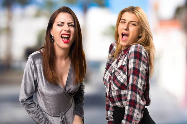 Due amici che gridano su uno sfondo sfocato — Foto Stock