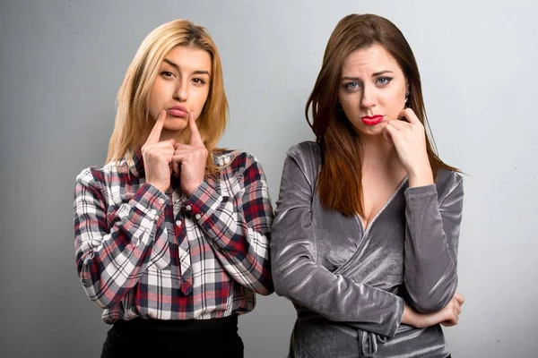 Two friends sad  on textured background — Stock Photo, Image