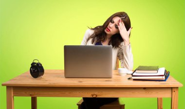 Onu laptop ile renkli ba üzerinde çalışan sinirli iş kadın