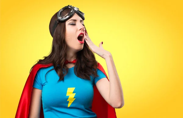 Muito menina super-herói bocejando no fundo colorido — Fotografia de Stock
