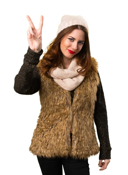 Dívka s zimní oblečení vítězství gesto — Stock fotografie