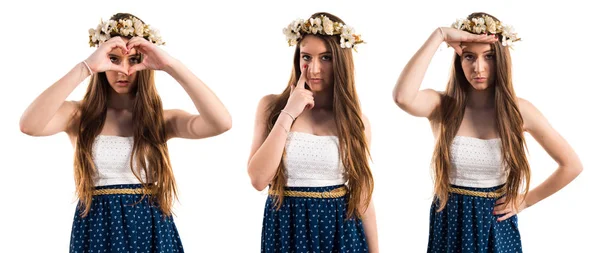 Girl with crown of flowers showing something — Stock Photo, Image