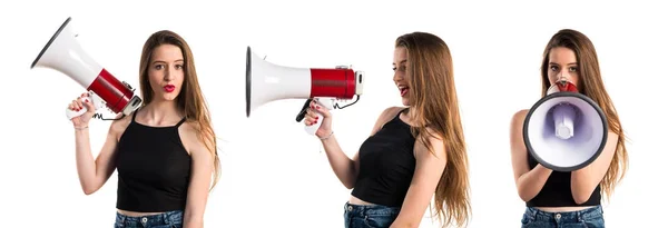 Young girl shouting by megaphone — Stock Photo, Image