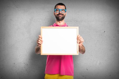 Renkli elbise boş bir afişini tutan adamla