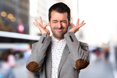 Yakışıklı adam kulakları odaklanmamış zemin üzerine kaplama