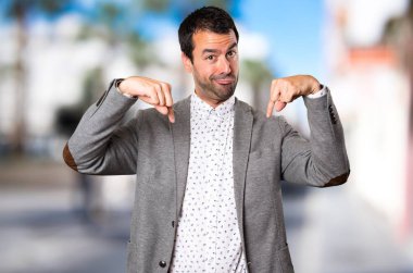 Yakışıklı adam odaklanmamış arka plan üzerinde aşağı dönük