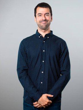 Gri arka plan üzerinde mutlu yakışıklı adam