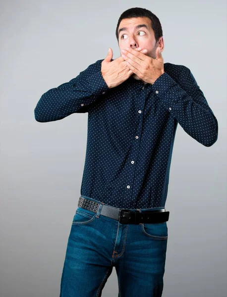 Yakışıklı adam yapma sürpriz jest gri arka plan üzerinde