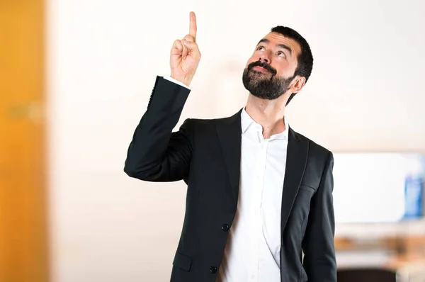 Handsome businessman pointing up in the office — Stock Photo, Image
