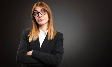 Koyu arka plan üzerinde düşünme genç iş kadını