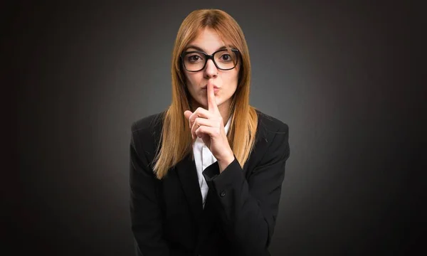 Young business woman making silence gesture on dark background — Stock Photo, Image