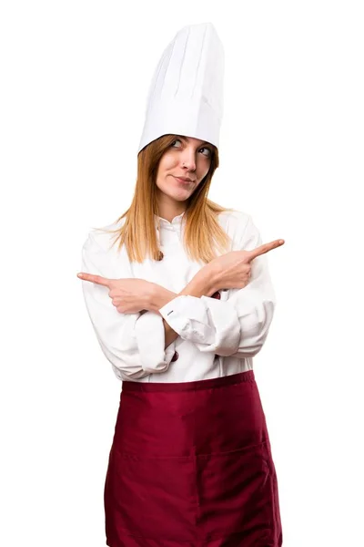 Beautiful chef woman pointing to the laterals having doubts — Stock Photo, Image