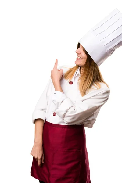 Beautiful chef woman pointing back