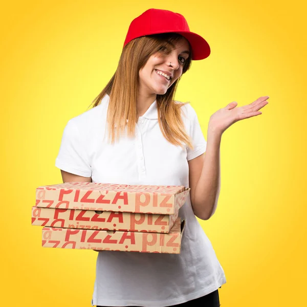 Доставка пиццы женщина представляет что-то на красочном фоне — стоковое фото